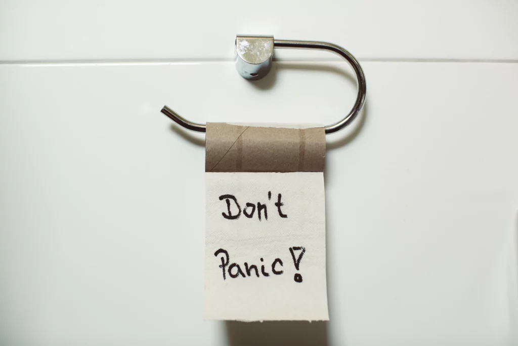 empty toilet holder with a sign that says Don't Panic