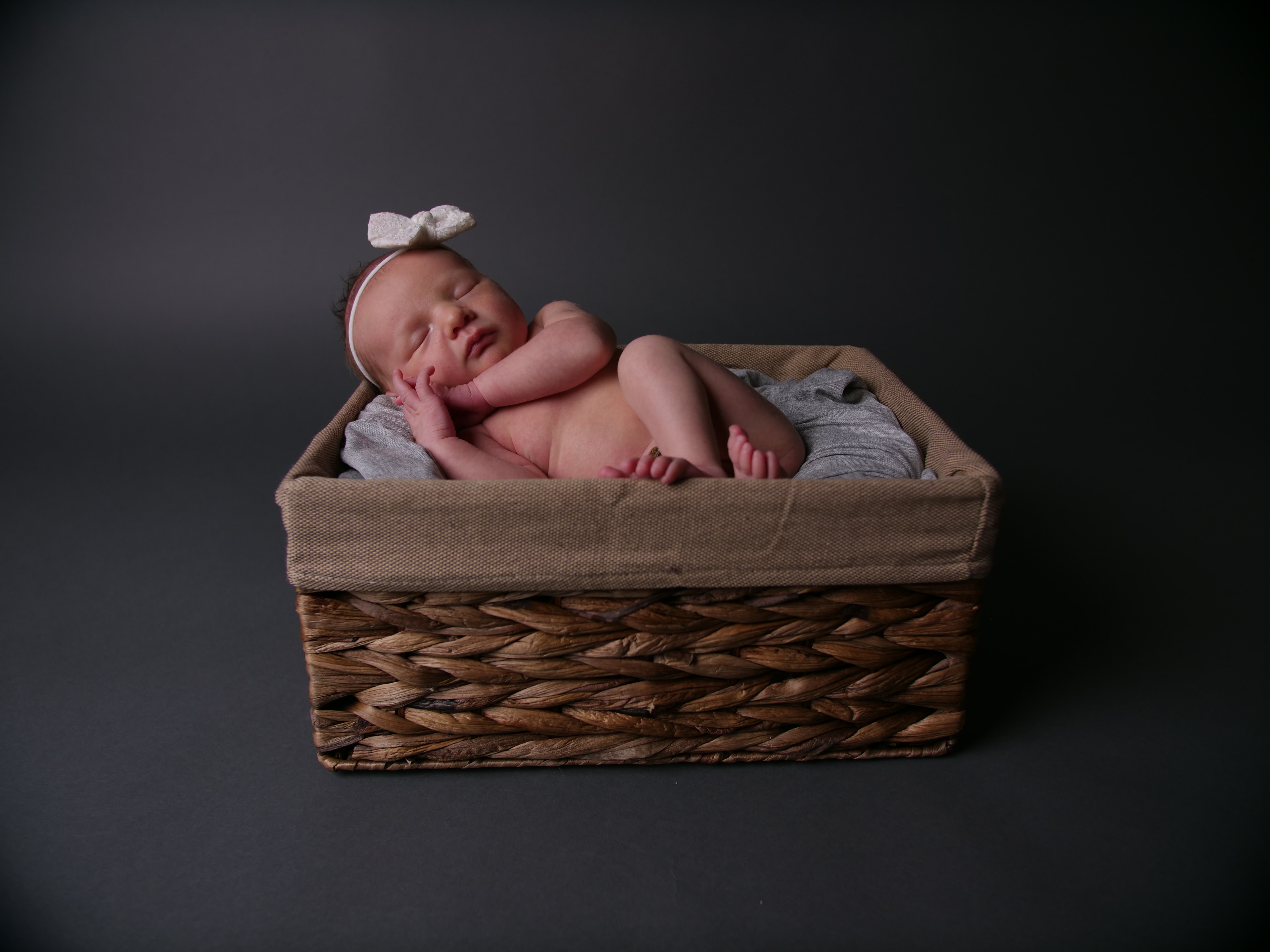 baby sleeping in box for photoshoot