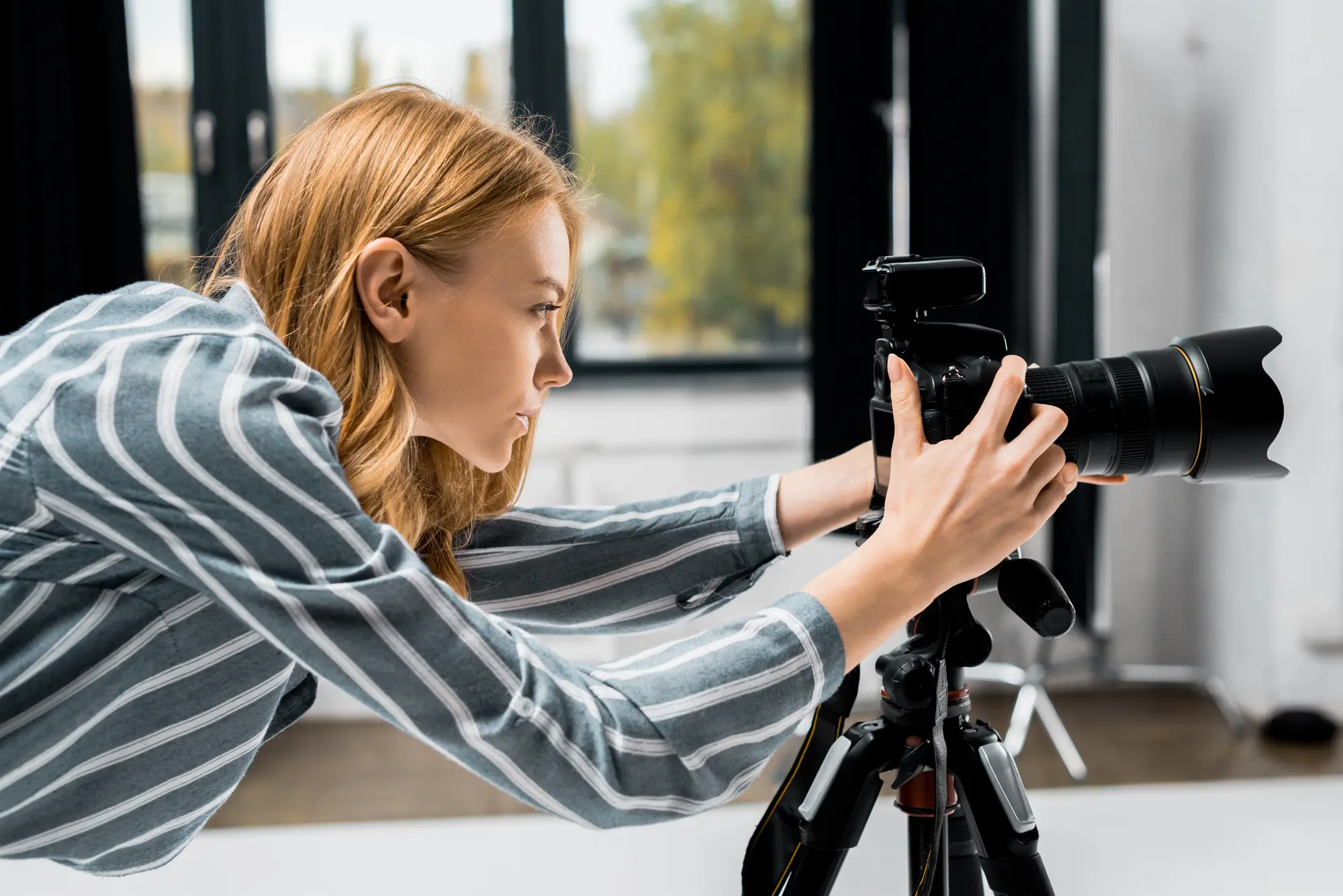 woman taking a photo with a professional camera on a tripod