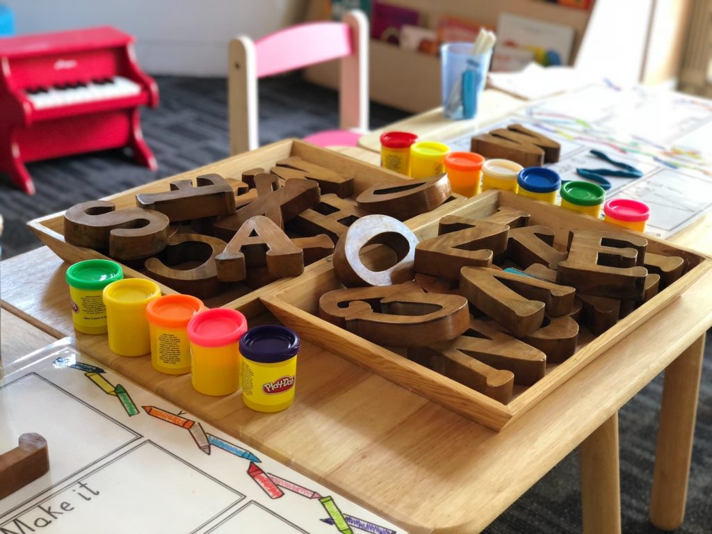 brown letters and playdoh on daycare table