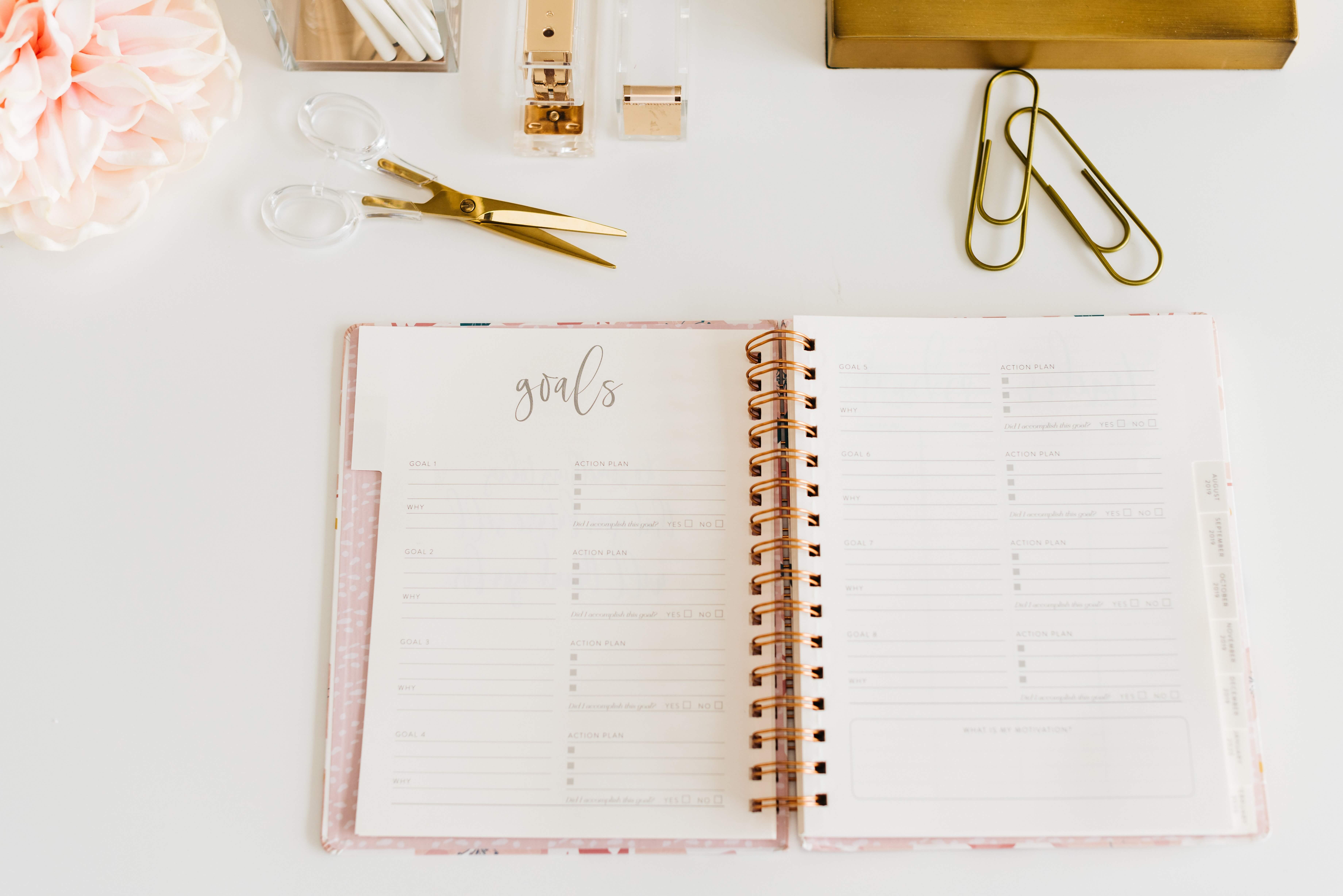 planner that says Goals on a desk with pretty gold office supplies
